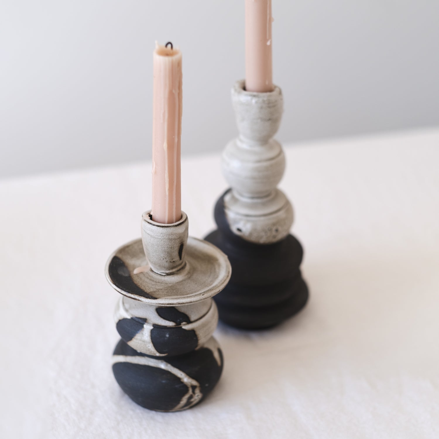 Small Handmade Ceramic Candle Holder in Black and White with a soft pink tapered candle